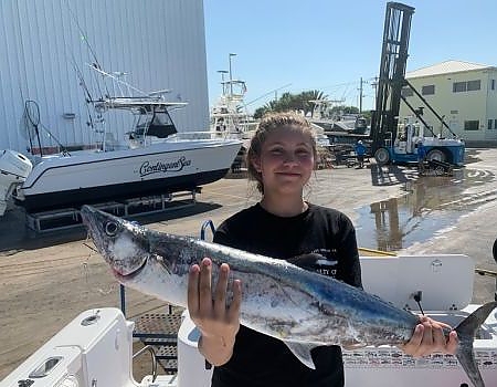  Young girl holds up fish