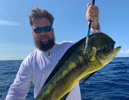  Man holds up huge fish caught on trip