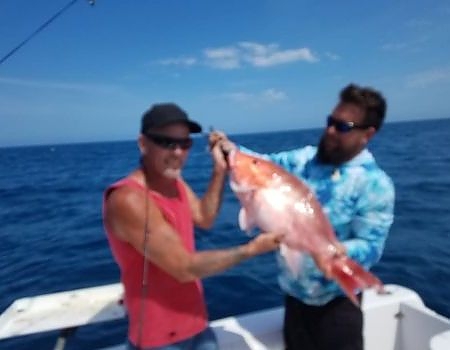 Two men holding up their catch