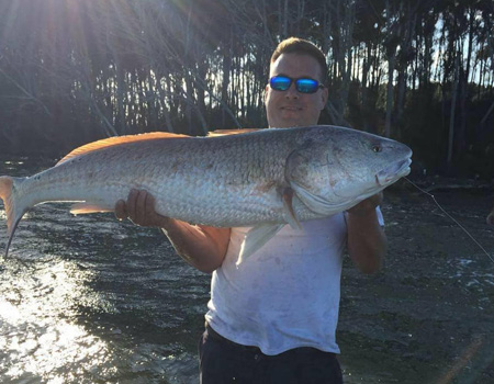 Holding up huge fish for the camera