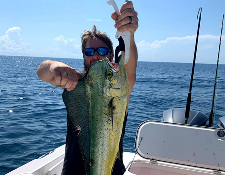  Man holding up large fish caught for the camera