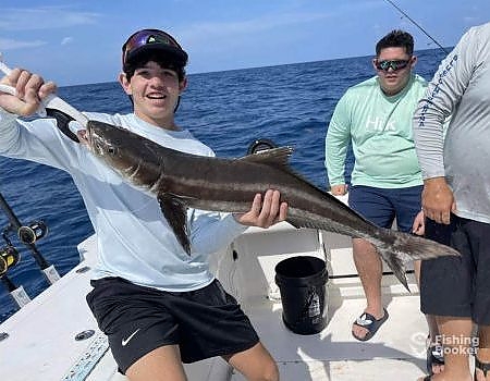  Young teen holding up fish