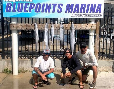  Group of men  posing below the Bluepoints Marina sign
