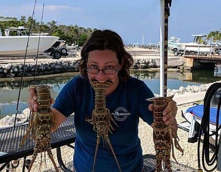  Holding up lobster catch after trip